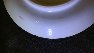 A Chinese famille rose cup and saucer with a lady and a boy, Yongzheng