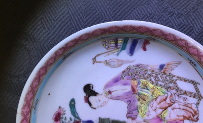 A Chinese famille rose cup and saucer with a lady and a boy, Yongzheng
