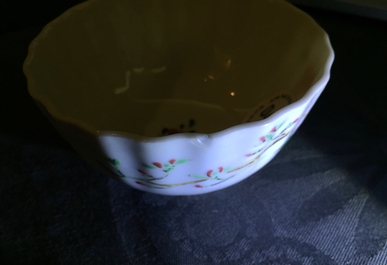A pair of Chinese famille rose cups and saucers with peacocks, Qianlong
