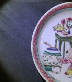 A Chinese famille rose cup and saucer with a lady and a boy, Yongzheng