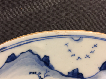 A fine pair of round Chinese blue and white landscape plaques, Kangxi