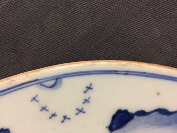 A fine pair of round Chinese blue and white landscape plaques, Kangxi