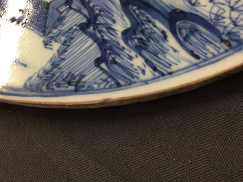 A fine pair of round Chinese blue and white landscape plaques, Kangxi