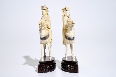 A pair of Chinese ivory warriors on horseback on wooden bases, 19th C.