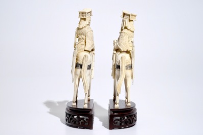 A pair of Chinese ivory warriors on horseback on wooden bases, 19th C.