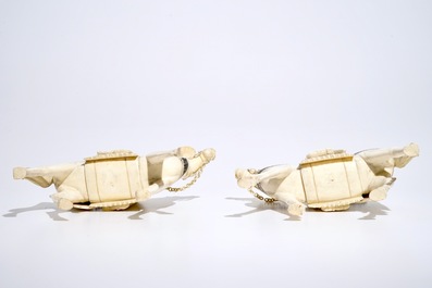 A pair of Chinese ivory warriors on horseback on wooden bases, 19th C.