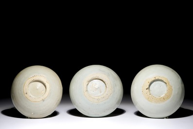 Three Chinese blue and white saucer plates with applied fish, Ming, 15th C.