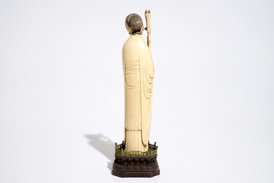 A Chinese ivory model of a lady on wooden base, 19th C.