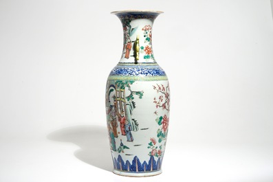 A tall Chinese famille rose vase with a court scene and peacocks, 19th C.