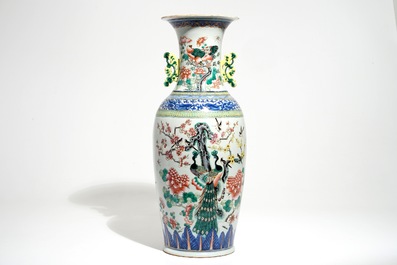 A tall Chinese famille rose vase with a court scene and peacocks, 19th C.