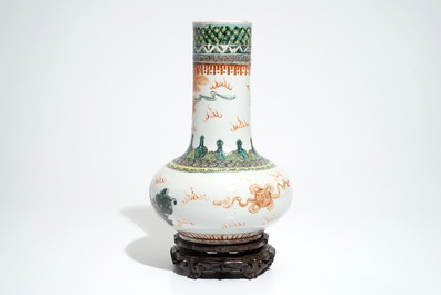 A Chinese famille verte vase with Buddhist lions on wooden stand, 19th C.