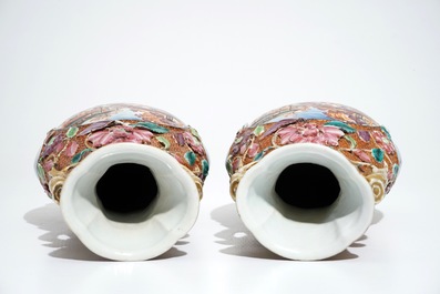 A pair of Chinese famille rose relief-decorated mandarin vases, Qianlong