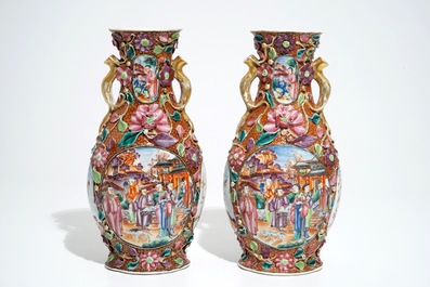 A pair of Chinese famille rose relief-decorated mandarin vases, Qianlong