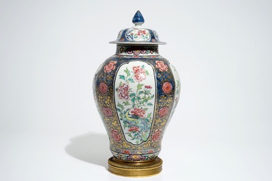 A Chinese bronze-mounted famille rose on blue-ground baluster vase and cover, Yongzheng