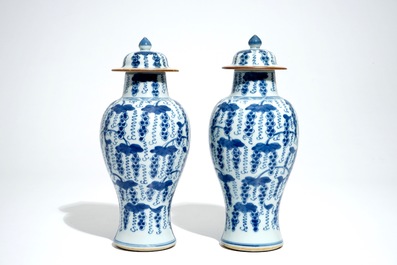 A pair of Chinese blue and white vases and covers with grapes, Kangxi