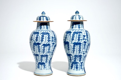 A pair of Chinese blue and white vases and covers with grapes, Kangxi