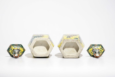 A pair of Chinese hexagonal famille verte yellow-ground vases and covers, 19th C.