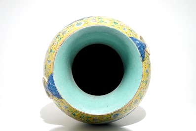 A tall Chinese famille rose yellow-ground vase with a tiger, Qianlong mark, 19th C.