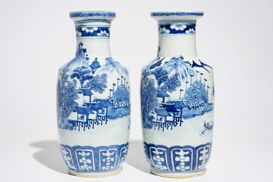 A pair of Chinese blue and white rouleau vases with landscape design, 19th C.