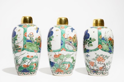 Three Chinese famille verte jars with floral design and gilt metal covers, Kangxi