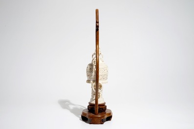 A Chinese encrusted ivory vase on wooden stand, early 20th C.