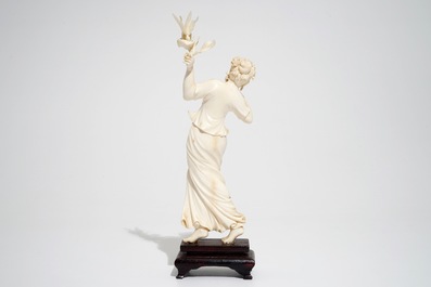 A Chinese ivory figure of a lady with a butterfly, early 20th C.