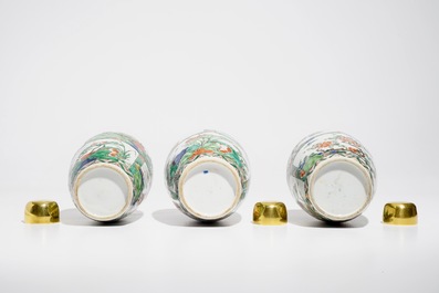 Three Chinese famille verte jars with floral design and gilt metal covers, Kangxi