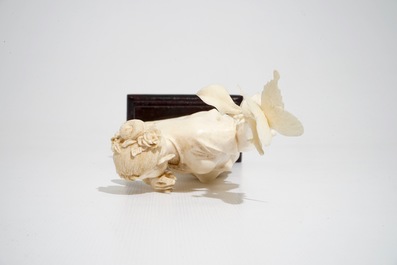 A Chinese ivory figure of a lady with a butterfly, early 20th C.