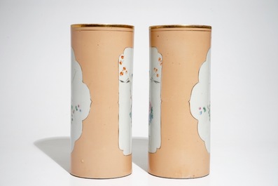 A pair of Chinese famille rose salmon pink-ground hat stands and a blue and white charger, 19/20th C.