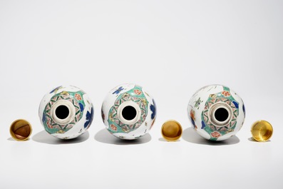 Three Chinese famille verte jars with floral design and gilt metal covers, Kangxi
