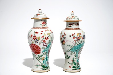 A pair of Chinese famille rose covered vases and four saucers, Yongzheng/Qianlong