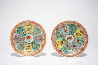 A pair of Chinese famille verte cups and saucers and four blue and white cups, Kangxi
