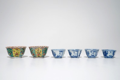 A pair of Chinese famille verte cups and saucers and four blue and white cups, Kangxi
