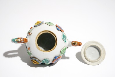 A Chinese famille rose teapot on stand with applied decoration, Yonzheng
