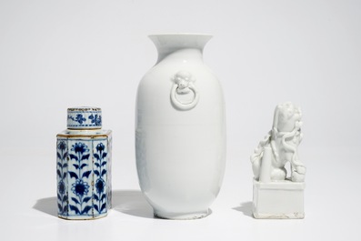 A Chinese Dehua blanc de Chine temple lion, a vase and a blue and white tea caddy, Kangxi and later