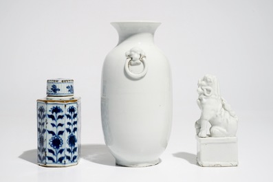 A Chinese Dehua blanc de Chine temple lion, a vase and a blue and white tea caddy, Kangxi and later
