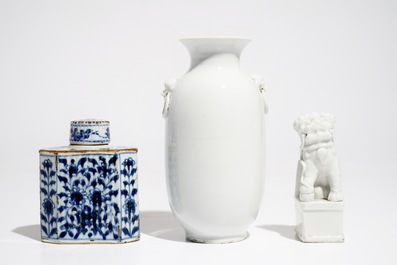 A Chinese Dehua blanc de Chine temple lion, a vase and a blue and white tea caddy, Kangxi and later