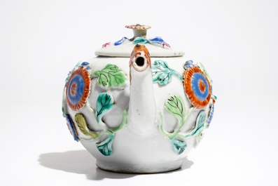 A Chinese famille rose teapot on stand with applied decoration, Yonzheng