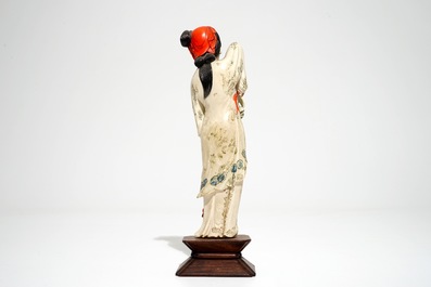 A Chinese polychrome ivory figure on wooden stand, 2nd quarter 20th C.