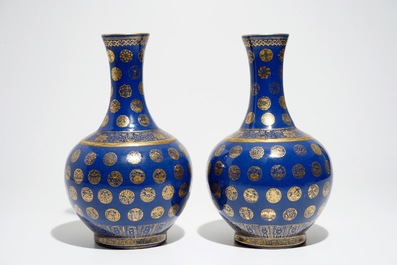 A pair of Chinese gilt-decorated powder blue-ground bottle vases, Qianlong mark, Guangxu