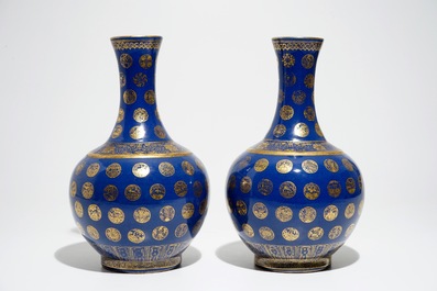 A pair of Chinese gilt-decorated powder blue-ground bottle vases, Qianlong mark, Guangxu