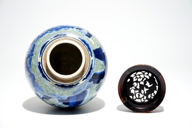 A Chinese famille verte jar with wooden cover and stand, Kangxi