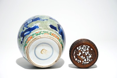 A Chinese famille verte jar with wooden cover and stand, Kangxi