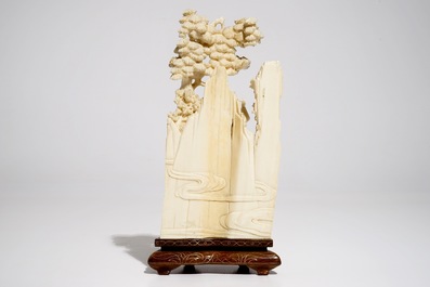A Chinese ivory group on wooden stand, 2nd quarter 20th C.