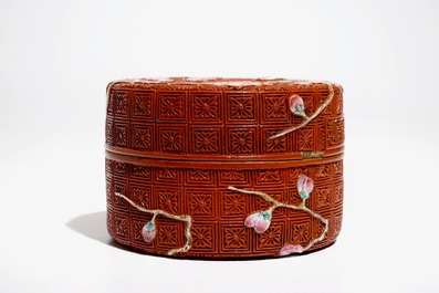 A Chinese porcelain imitation lacquerware covered box with prunus branches, 19/20th C.