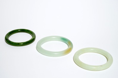 Three Chinese celadon and spinach green jade bangles, 19/20th C.