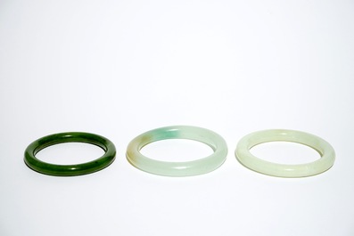 Three Chinese celadon and spinach green jade bangles, 19/20th C.