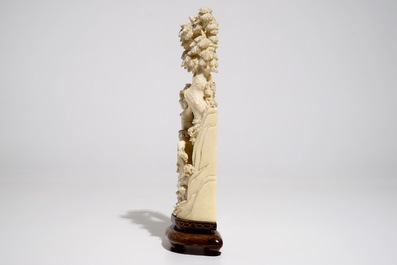 A Chinese ivory group on wooden stand, 2nd quarter 20th C.