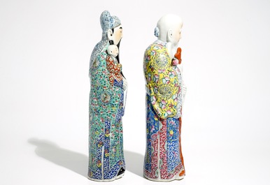 A pair of Chinese famille rose figures of immortals on wooden bases, 19/20th C.