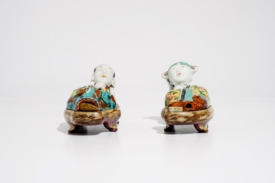 A pair of Chinese famille rose wall pocket vases shaped as resting figures, early 19th C.